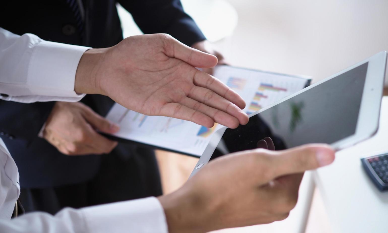 Professional team reviewing financial reports in modern office setting